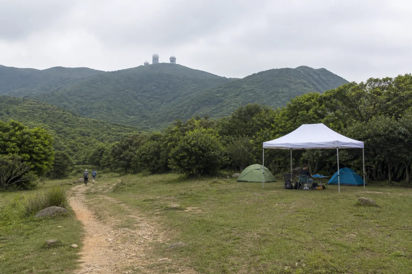 Pop-up canopy in a camp or field setting