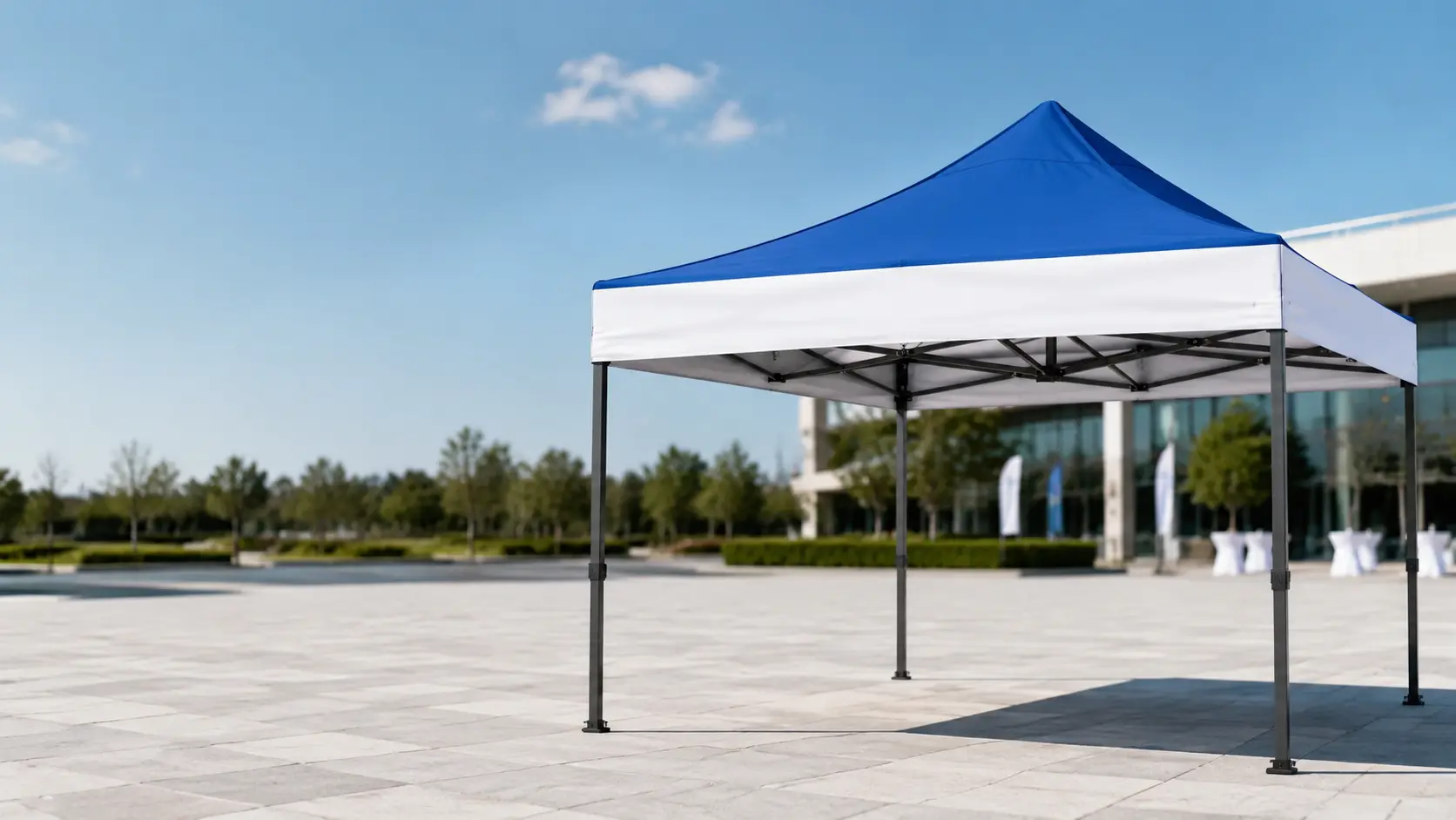 Blue commercial standard steel pop-up canopy tent in an outdoor event setting